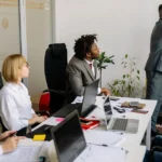 Thank you for the clarification. Here's the corrected **alt text** using the exact keyword: **Alt Text:** Team participating in leadership development programs during an interactive office training session.