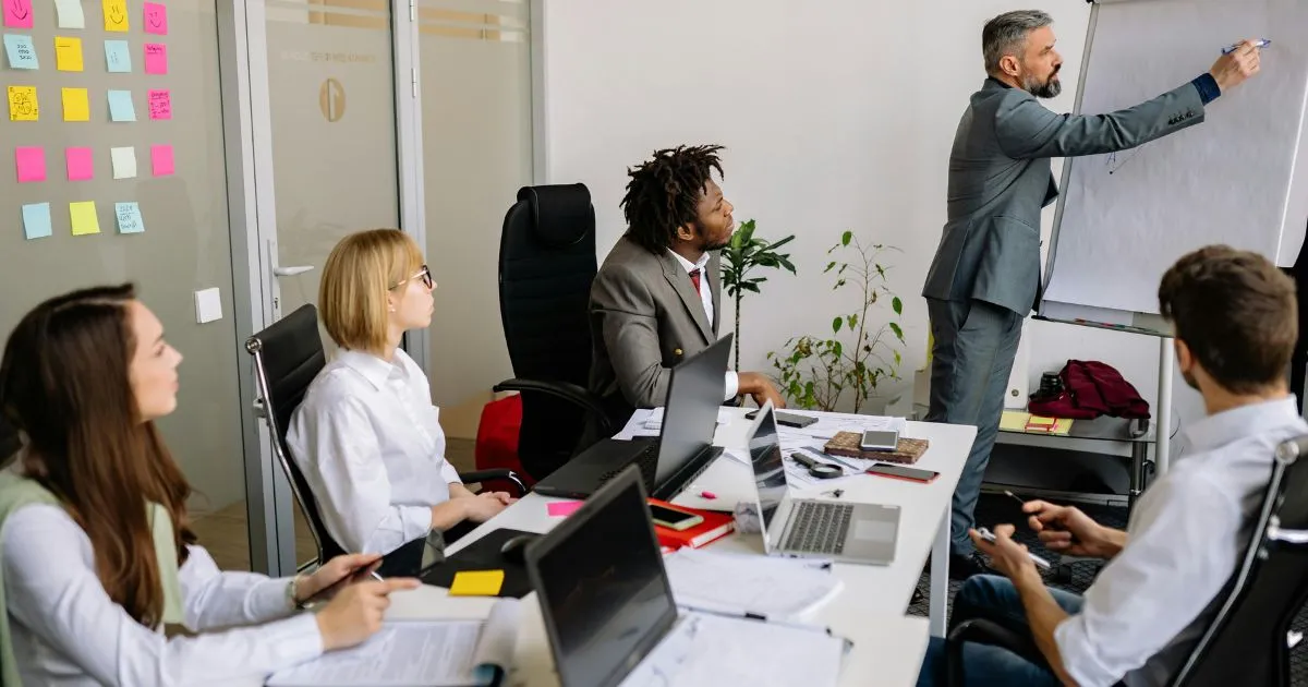 Thank you for the clarification. Here's the corrected **alt text** using the exact keyword: **Alt Text:** Team participating in leadership development programs during an interactive office training session.
