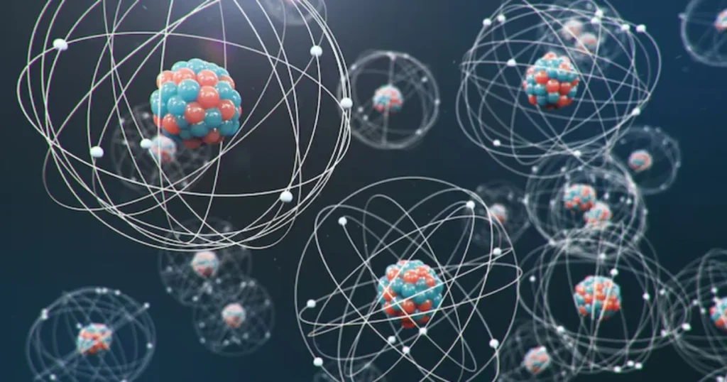 Two stylized models of atomic structures, one glowing and one metallic, illustrating atomic structure concepts.